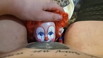 Girl fucks a clown doll